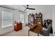 Bedroom featuring a ceiling fan, two windows with blinds, and built-in bookshelves at 4715 Mcintosh Drive Dr, Cumming, GA 30040