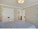 Bedroom with a patterned wall, closet and ensuite bathroom at 4715 Mcintosh Drive Dr, Cumming, GA 30040