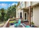 Outdoor deck with teal chairs overlooking landscaped yard and fenced-in area at 4715 Mcintosh Drive Dr, Cumming, GA 30040
