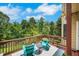 Inviting outdoor deck featuring teak furnishings and a view of a private, wooded lot at 4715 Mcintosh Drive Dr, Cumming, GA 30040