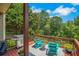 Outdoor deck with green views, seating, and a grill for entertaining at 4715 Mcintosh Drive Dr, Cumming, GA 30040