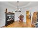 Dining room with hardwood floors, large hutch, elegant chandelier, wainscoting and backyard views at 4715 Mcintosh Drive Dr, Cumming, GA 30040