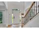 Inviting foyer with wood floors, a bright white front door, and trim on the staircase and columns at 4715 Mcintosh Drive Dr, Cumming, GA 30040