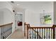 Bright foyer with hardwood railing, wrought iron spindles and decorative light fixture at 4715 Mcintosh Drive Dr, Cumming, GA 30040