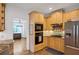 Kitchen with stainless steel appliances, wooden cabinets and granite countertops overlooking adjacent room at 4715 Mcintosh Drive Dr, Cumming, GA 30040