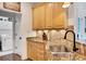 Kitchen features granite countertops, stainless steel sink, and easy access to the laundry room at 4715 Mcintosh Drive Dr, Cumming, GA 30040