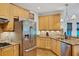 Eat-in kitchen featuring wooden cabinets, stainless steel appliances, and granite countertops at 4715 Mcintosh Drive Dr, Cumming, GA 30040