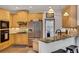 Kitchen with wooden cabinets, stainless steel appliances, and granite countertops with seating area at 4715 Mcintosh Drive Dr, Cumming, GA 30040