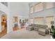 Bright living room with soaring ceilings, multiple windows, and an open floor plan to the kitchen and dining area at 4715 Mcintosh Drive Dr, Cumming, GA 30040