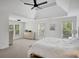 Spacious primary bedroom with tray ceiling, fan, and windows with light-filtering blinds at 4715 Mcintosh Drive Dr, Cumming, GA 30040