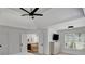 Bright primary suite showcases a ceiling fan, tray ceilings, and an attached bathroom at 4715 Mcintosh Drive Dr, Cumming, GA 30040