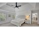 Airy primary bedroom boasts tray ceiling, ceiling fan, and neutral décor at 4715 Mcintosh Drive Dr, Cumming, GA 30040