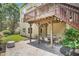 Rear patio features outdoor dining area with a natural stone patio and view of manicured grounds at 4715 Mcintosh Drive Dr, Cumming, GA 30040
