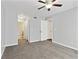 Bedroom with neutral carpet, ceiling fan, closet doors, and bathroom entrance at 2657 Lenox Ne Rd # 134-2, Atlanta, GA 30324