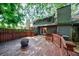 Inviting backyard with a spacious deck, fire pit, and lush green surroundings, great for entertaining at 1002 Creatwood Se Cir, Smyrna, GA 30080