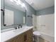 Well-lit bathroom featuring a modern vanity, a large mirror, and a shower-tub combo at 1002 Creatwood Se Cir, Smyrna, GA 30080