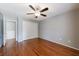 Cozy bedroom with hardwood floors, neutral walls, and a double-door closet at 1002 Creatwood Se Cir, Smyrna, GA 30080