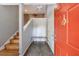 Inviting entryway with staircase, a wooden bench, and a striking front door at 1002 Creatwood Se Cir, Smyrna, GA 30080