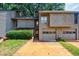 Charming townhouse with a two-car garage and lush green landscaping at 1002 Creatwood Se Cir, Smyrna, GA 30080