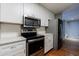 Well-lit kitchen featuring stainless steel appliances, white cabinetry, and a stylish subway tile backsplash at 1002 Creatwood Se Cir, Smyrna, GA 30080