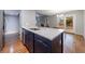 Open kitchen with island, stainless steel appliances, and hardwood floors at 1002 Creatwood Se Cir, Smyrna, GA 30080