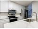 Modern kitchen with white cabinets and stainless steel appliances at 1002 Creatwood Se Cir, Smyrna, GA 30080