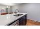 Modern kitchen island featuring a stainless steel sink, sleek faucet, and a white countertop at 1002 Creatwood Se Cir, Smyrna, GA 30080