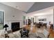 Open-concept living room with fireplace, seamlessly connecting to dining area at 1002 Creatwood Se Cir, Smyrna, GA 30080