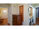 Hallway featuring an antique dresser and a laundry room with modern appliances and cabinets at 1245 Briar Hills Ne Dr, Atlanta, GA 30306