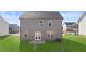 Large backyard featuring a lush green lawn and grey siding at 169 Aster Avenue, Locust Grove, GA 30248