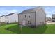 Spacious backyard with lush green lawn and grey siding at 169 Aster Avenue, Locust Grove, GA 30248