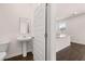 Stylish half bathroom with modern fixtures and adjacent kitchen area at 169 Aster Avenue, Locust Grove, GA 30248