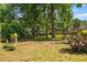 An outdoor swing set and garden are set amongst the trees in this backyard at 1809 Claron Ave, Conley, GA 30288