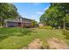 Expansive backyard featuring a well-maintained lawn, mature trees, and a charming deck for outdoor enjoyment at 1809 Claron Ave, Conley, GA 30288