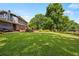 Beautiful backyard with a deck, manicured lawn, and mature trees at 1809 Claron Ave, Conley, GA 30288
