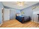 This bedroom features a bed, ceiling fan, closet and wood-look flooring at 1809 Claron Ave, Conley, GA 30288