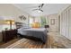 Comfortable bedroom with hardwood floors, ceiling fan, and natural light at 1809 Claron Ave, Conley, GA 30288