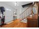 Inviting foyer with hardwood floors, staircase, and ample natural light from the front door at 1809 Claron Ave, Conley, GA 30288