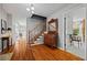 Bright foyer featuring hardwood floors, staircase with wooden banister, and adjacent living spaces at 1809 Claron Ave, Conley, GA 30288