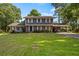 Charming two-story home with a lush green lawn, mature trees and a covered carport at 1809 Claron Ave, Conley, GA 30288