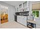 Bright kitchen features white cabinetry, stainless steel appliances, and a view into the adjacent dining room at 1809 Claron Ave, Conley, GA 30288