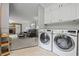 Convenient laundry room with modern washer and dryer and view into living area at 1809 Claron Ave, Conley, GA 30288