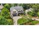 Gorgeous aerial view of a two-story home featuring a brick exterior, dark roof, and a spacious driveway at 819 Loridans Dr, Atlanta, GA 30342