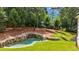 Relaxing backyard featuring a custom stone waterfall feature that empties into a backyard pool at 819 Loridans Dr, Atlanta, GA 30342