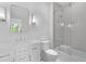 Bright bathroom featuring a vanity with storage, a toilet, a mirror, and a shower-tub combination with glass door at 819 Loridans Dr, Atlanta, GA 30342