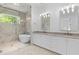 Contemporary bathroom featuring double sinks, a soaking tub, walk-in shower, and stylish lighting at 819 Loridans Dr, Atlanta, GA 30342