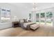 Bright main bedroom features hardwood floors, large windows and access to a backyard patio at 819 Loridans Dr, Atlanta, GA 30342