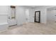 Bright entryway featuring light-colored floors, a bench, access to the bathroom and rear deck at 819 Loridans Dr, Atlanta, GA 30342