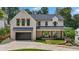 Beautiful brick two-story home with a dark roof, inviting front porch, and well-manicured lawn at 819 Loridans Dr, Atlanta, GA 30342
