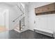 Inviting foyer with staircase, herringbone floors, mudroom storage, and bench seating creates an organized entry at 819 Loridans Dr, Atlanta, GA 30342